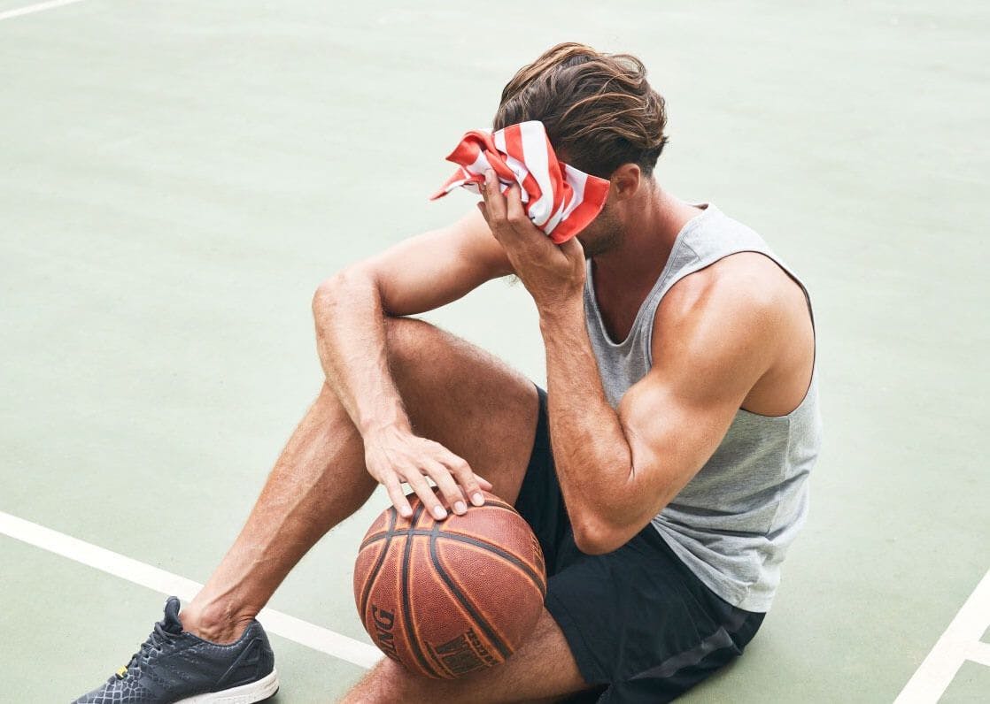 Persona secándose el sudor jugando al baloncesto